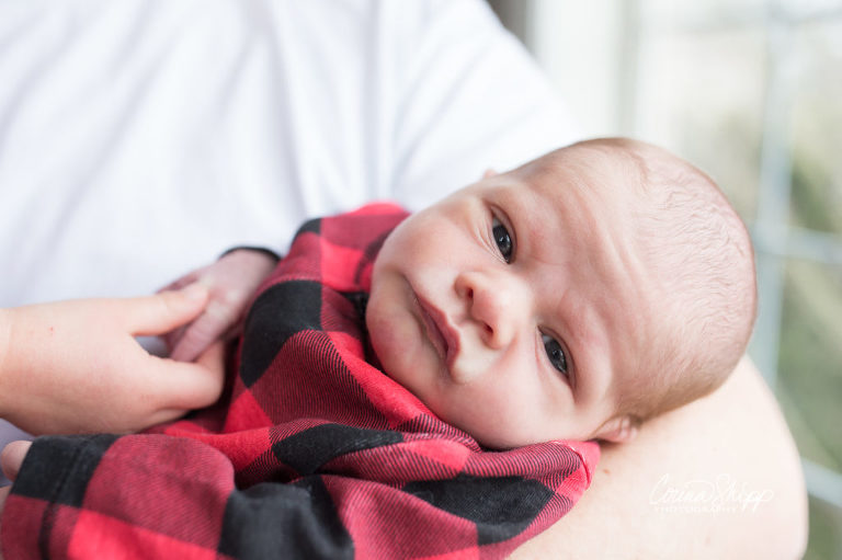 Newborn Lifestyle Photographer in Vancouver WA - wide eyed newborn in dad's arms