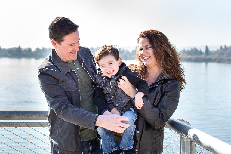 Corina Shipp Photography-Vancouver Wa Family Photographer-Dad and mom hold and tickle son at the waterfront